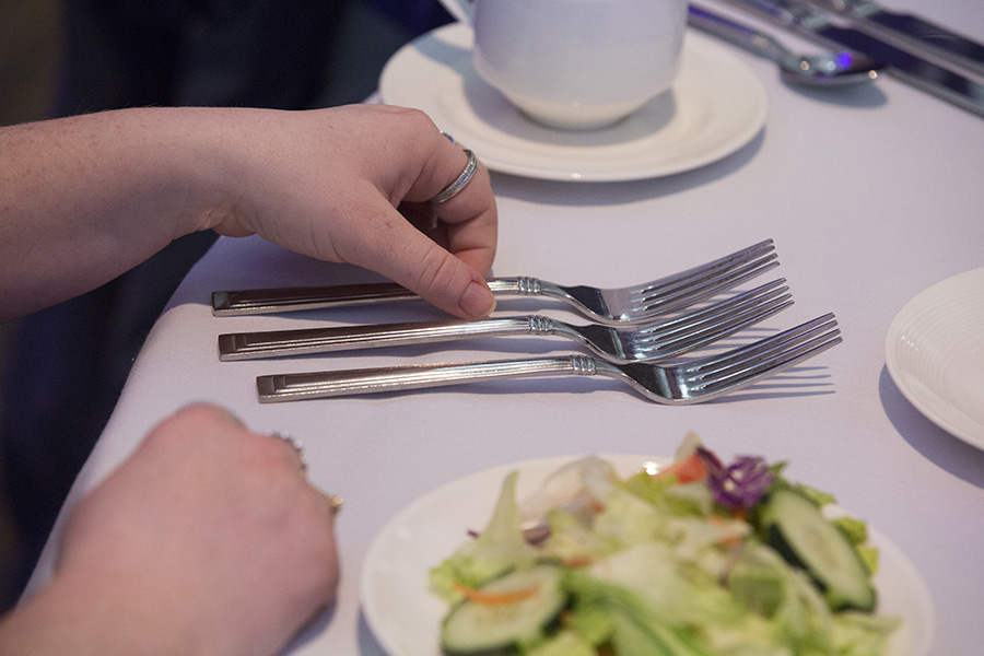 Table setting with forks and a salad.