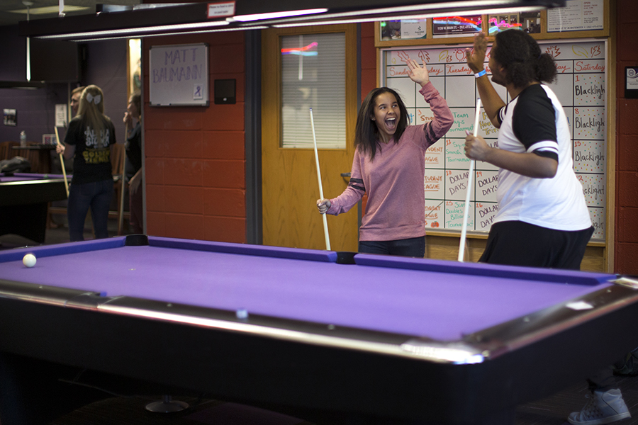Two students playing pool.