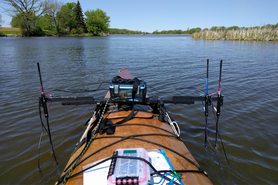 Electronic mapping equipment mounted on a kayak going down a river.