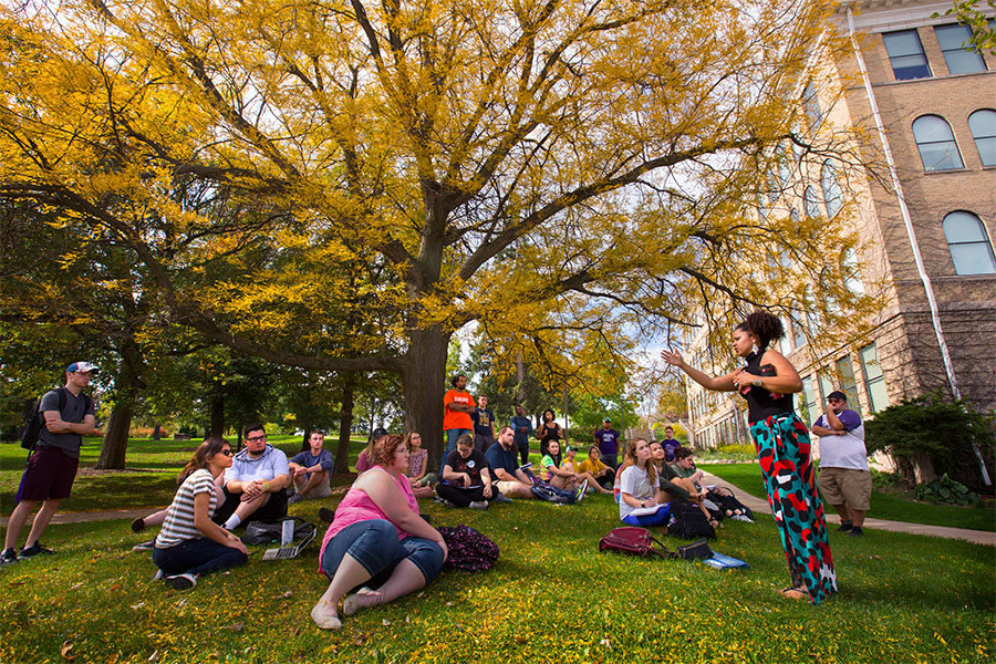 students enjoy an outdoor class at UW-Whitewater on an autumn day.