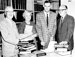 Photo of Helen Herbert filing her master's thesis at Andersen Library