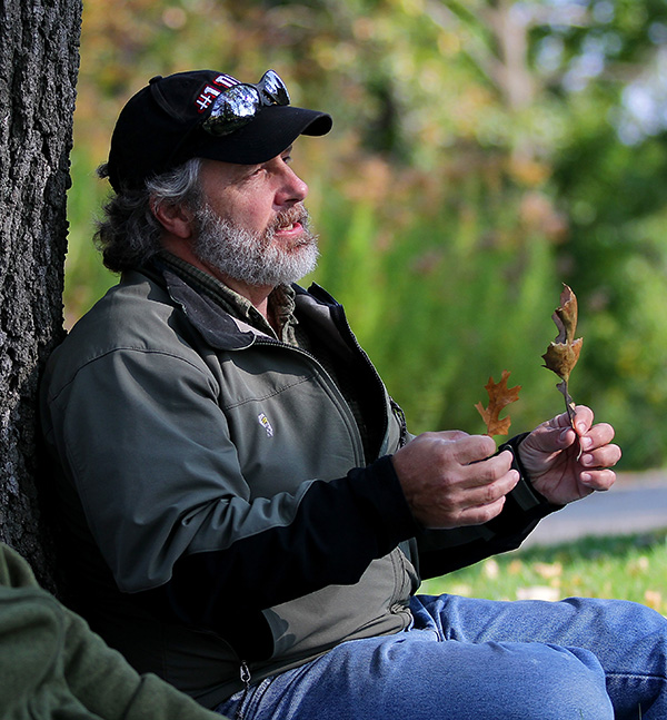 Tony Gulig stands against a tree outside.