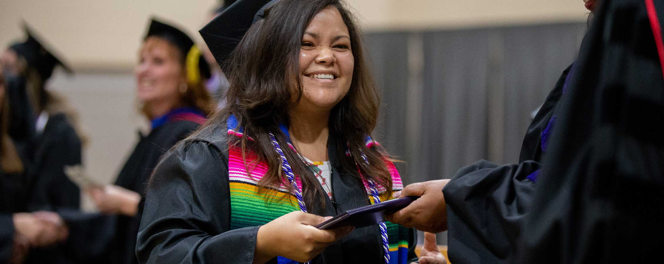 Smiling woman receiving diploma