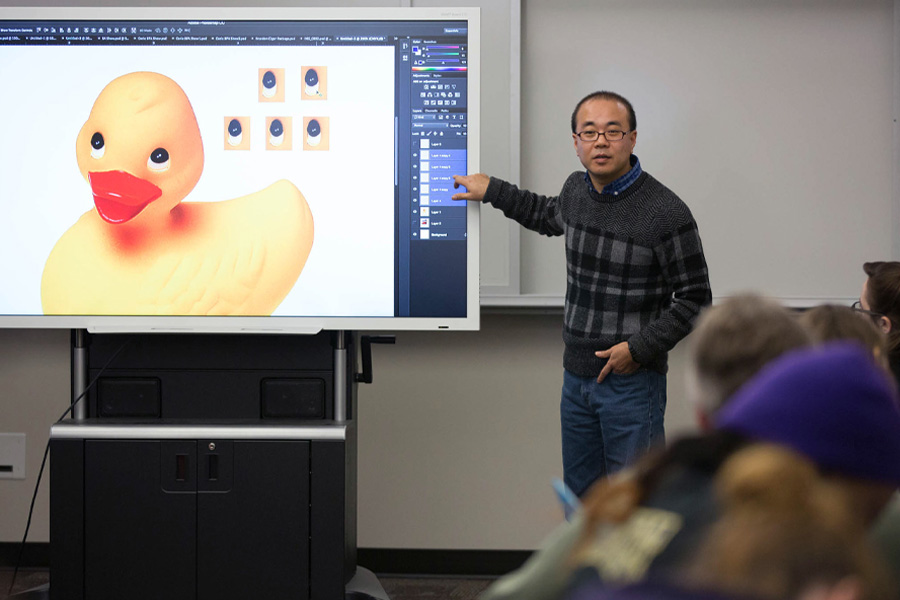 Dan Kim teaches Adobe software with a yellow duck on the screen.