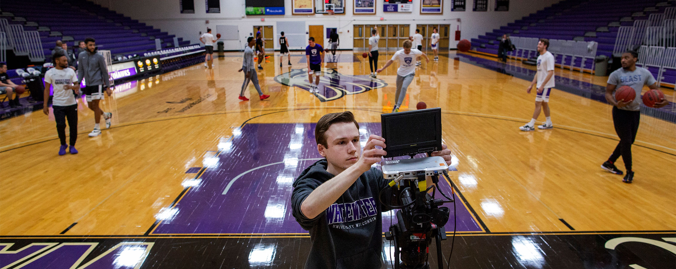  Student sets up camera to broadcast a basketball game at UW-Whitewater.