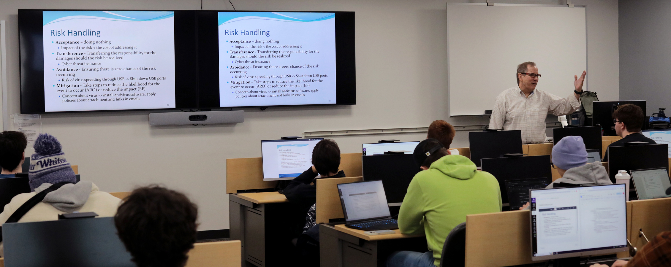 A faculty member speaks in front of a Cyber 101 class.