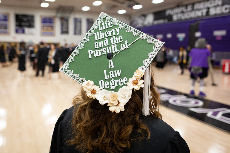 A student's cap at graduation says life liberty and the pursuit of a law degree.