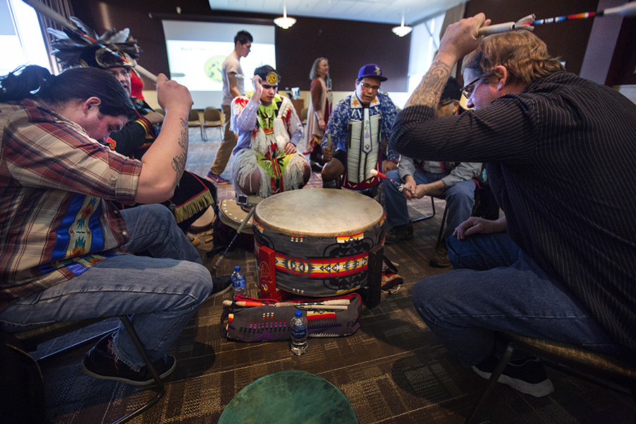 Six members of the Red Cliff Band of Lake Superior Chippewa perform traditional drumming.