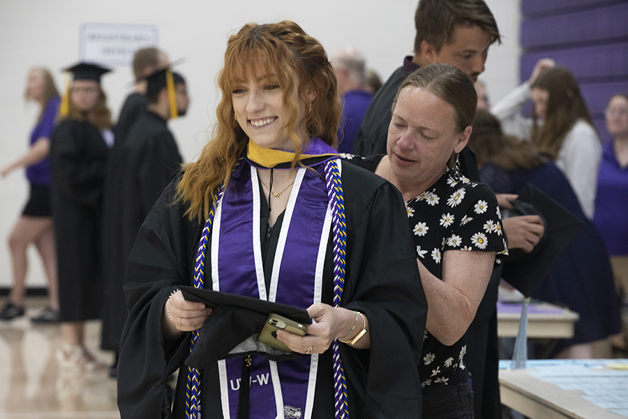 A social work student smiles at Commencement.