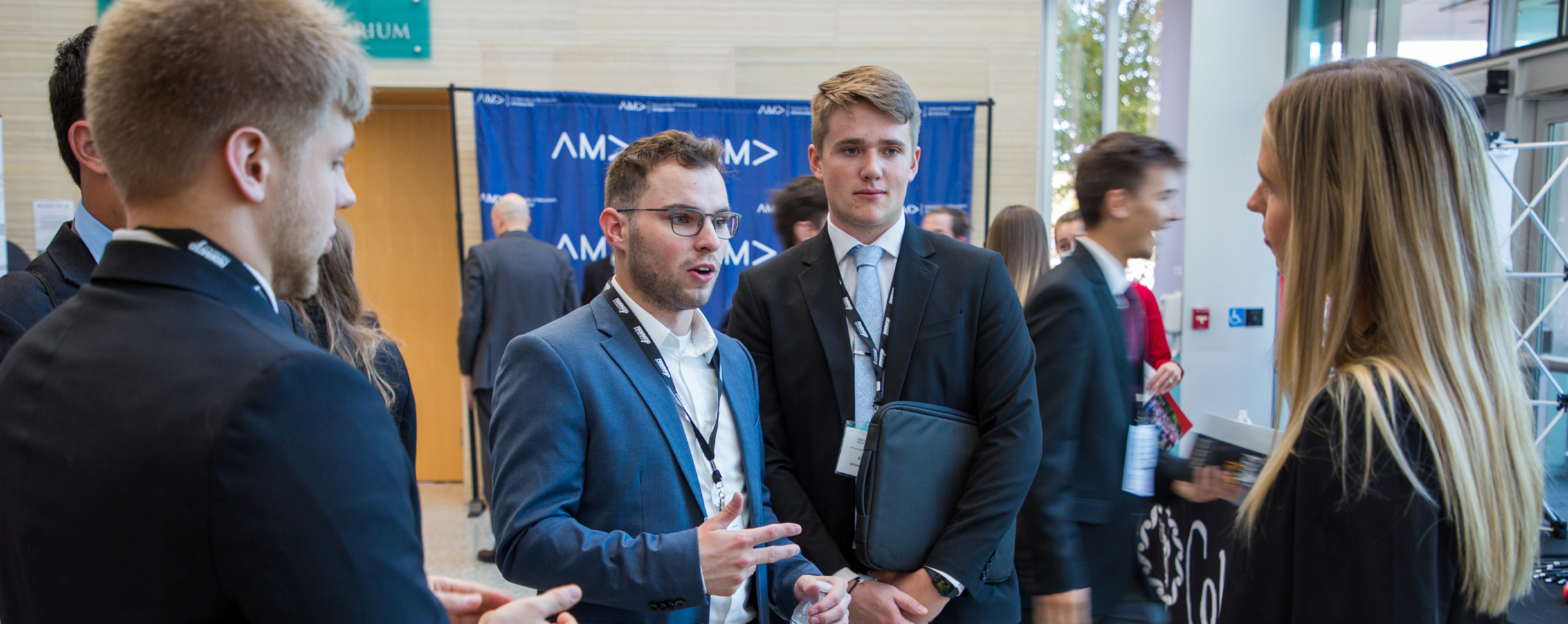 A group of well dressed students interact with each other.