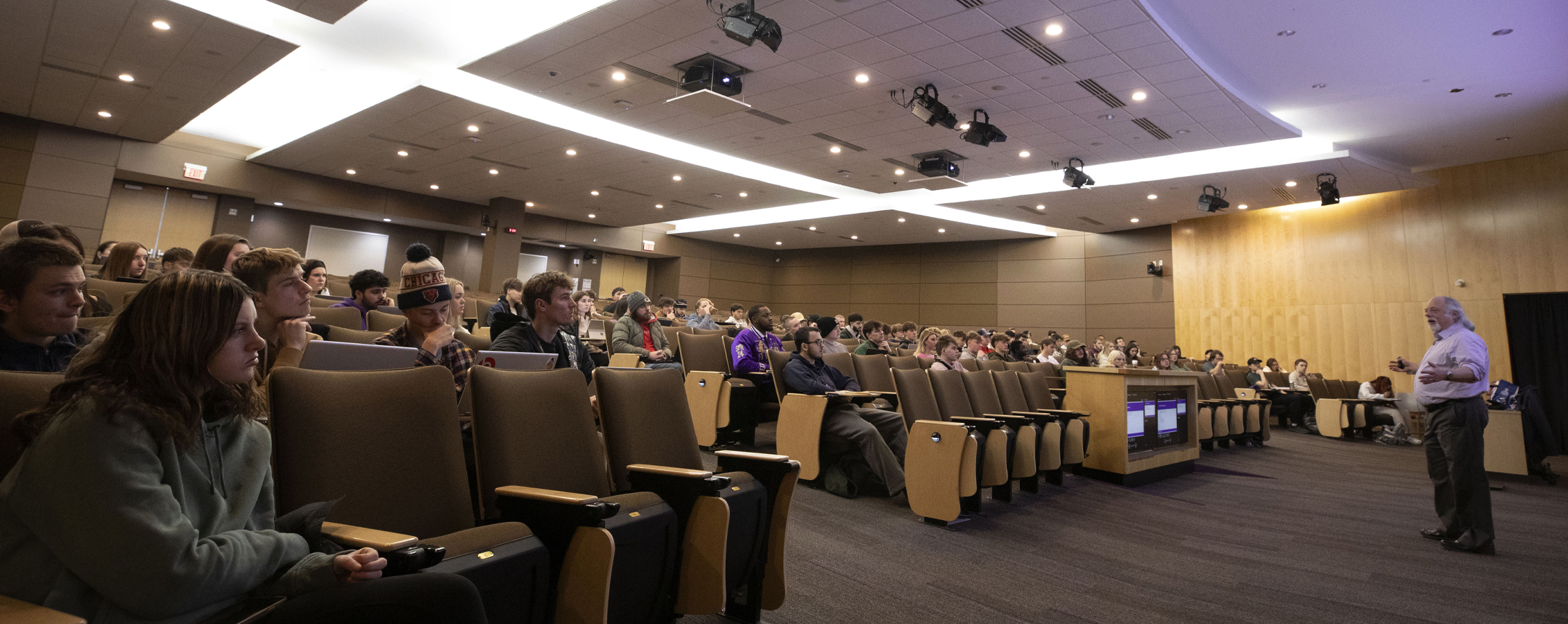 Students attend class in a lecture hall.