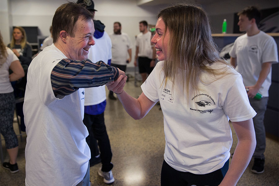 UW-Whitewater Special Education student smiles and shakes hands