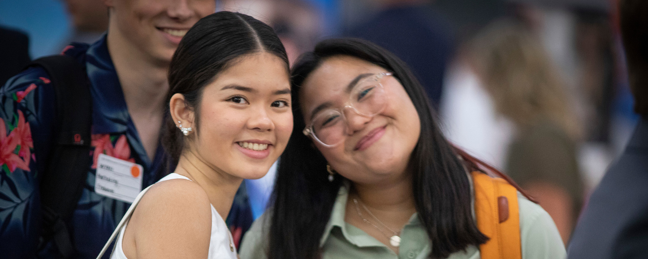 Two women smiling at a recruitment fair