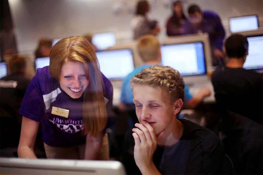  Students work on a computer together on the UW-Whitewater campus.