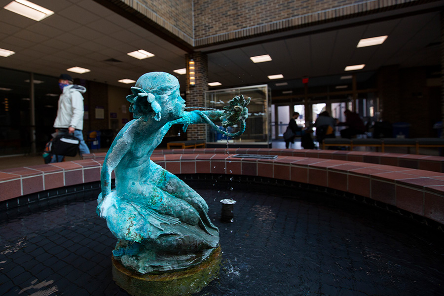 A student high fives near his undergraduate research project.