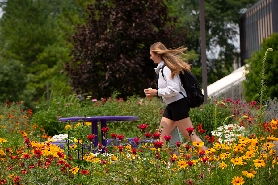 UW-Whitewater student relaxes on a bench outside McGraw Hall on the UW-Whitewater campus.