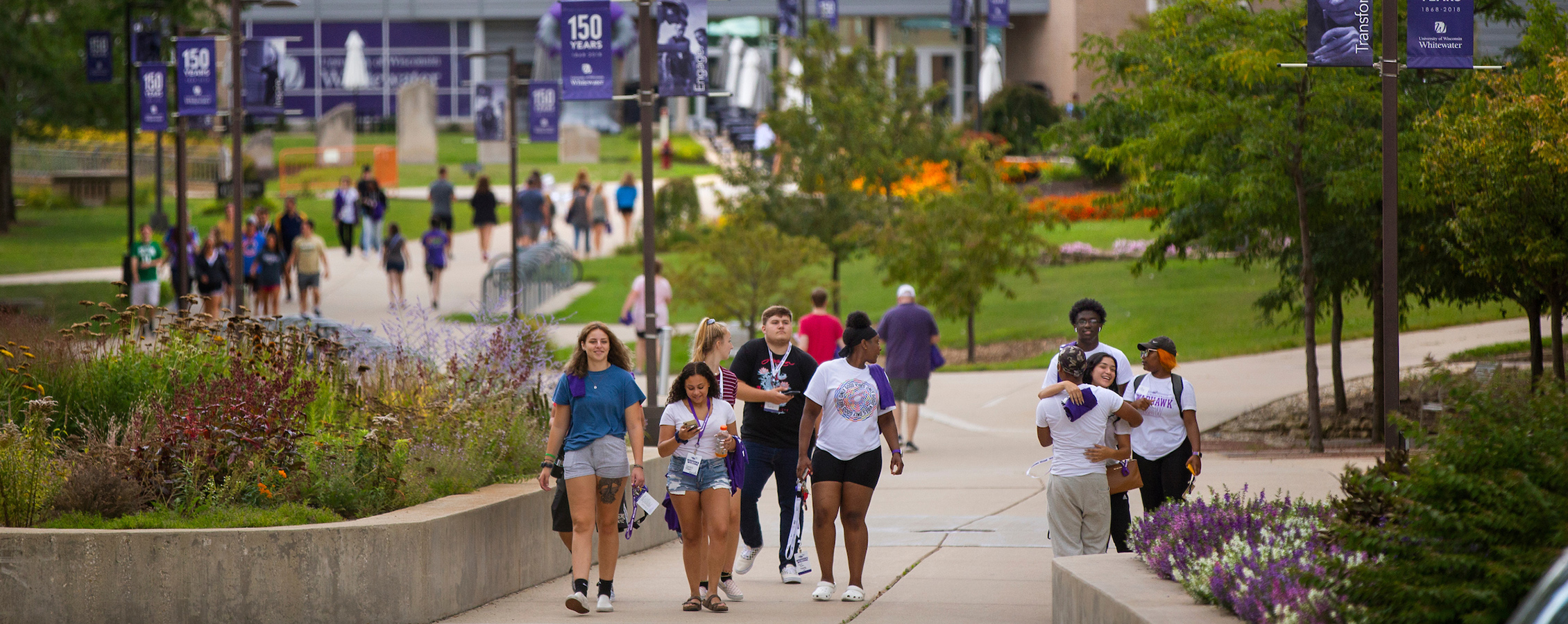 Image of the center of campus at UW-Whitewater with students walking down the sidewalks