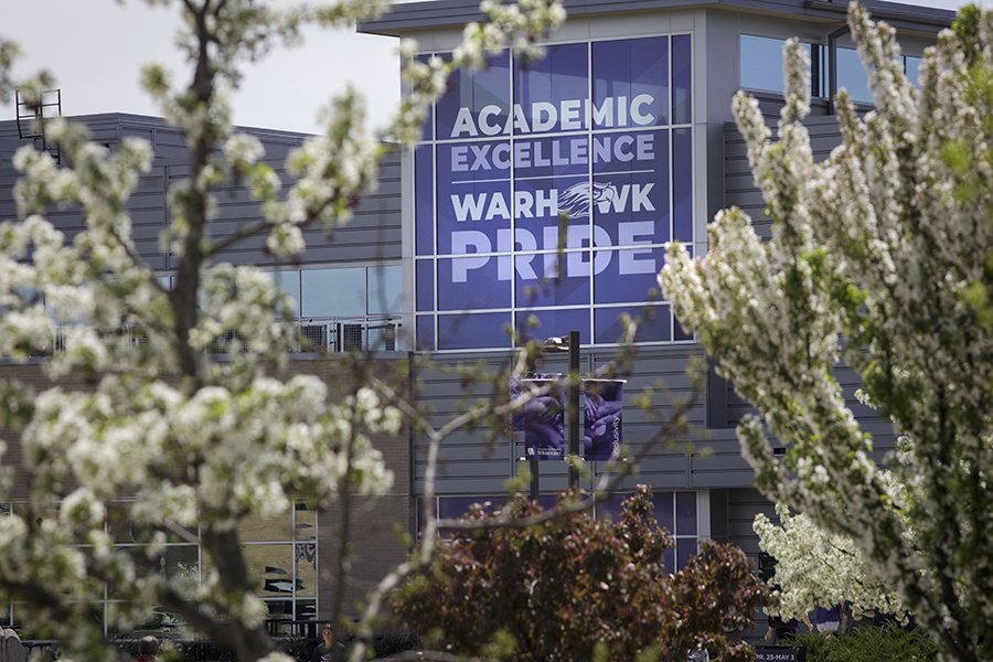 A purple banner on the University Center that says You Belong Here and Academic Pride.