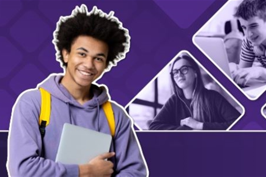 Student smiles with laptop in hands