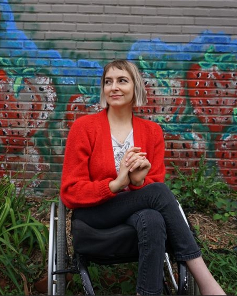 Rebekah Taussing poses in front a a painted wall | Photo submitted by Rebekah Taussig