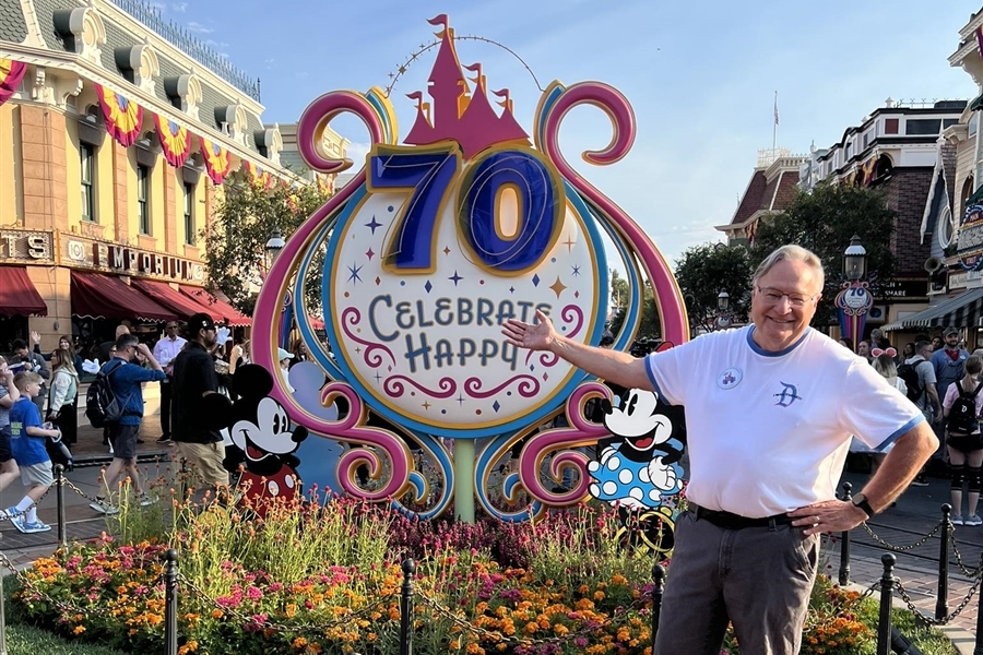 Michael points to 70 year sign at Disney