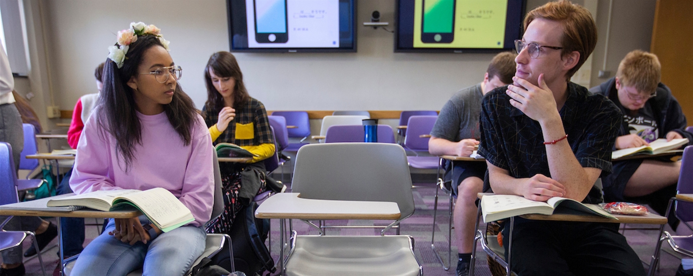 Two ladies read a book in the University Center