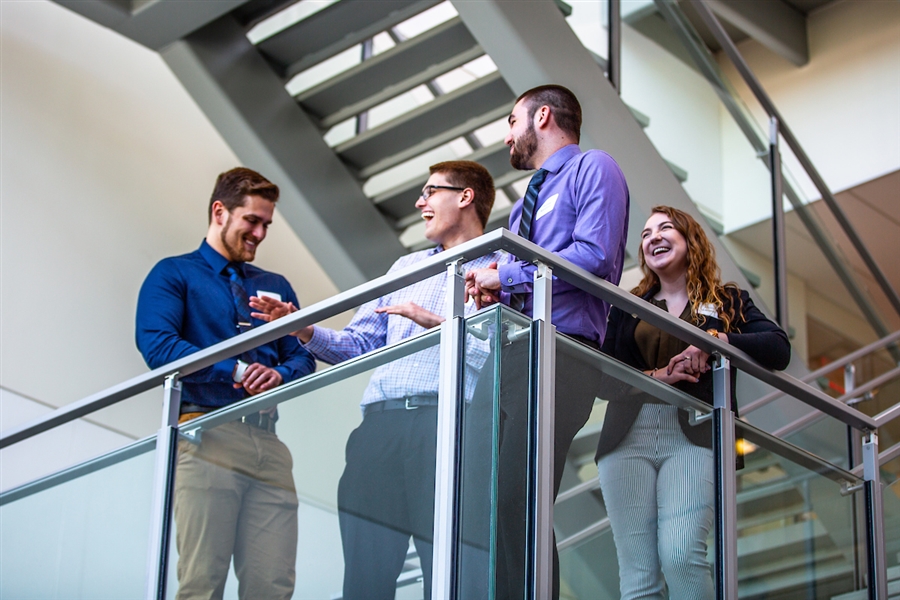 Students sharing stories on the stairs: UW-WHITEWATER PHOTO/CRAIG SCHREINER