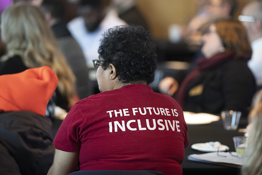 A person wears a shirt that says The Future Is Inclusive.