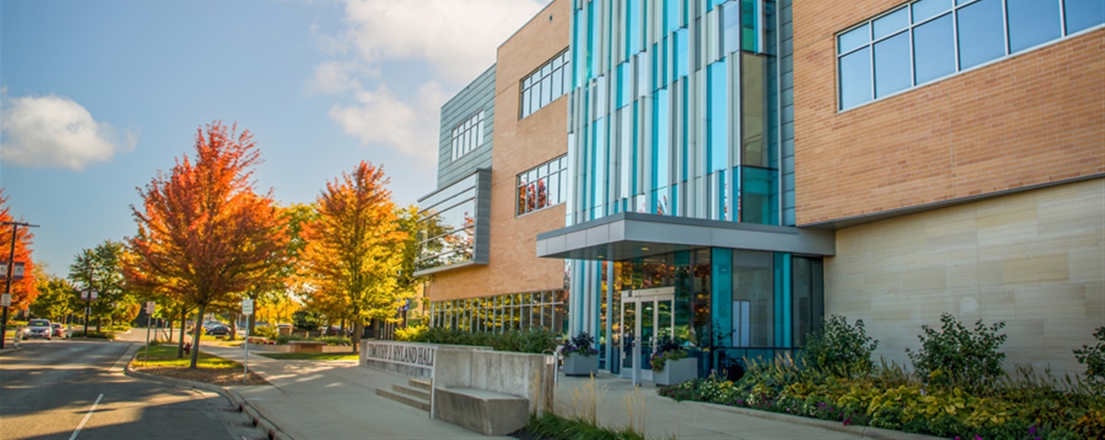 Outside photo of Hyland hall with fall trees in the backgrounds