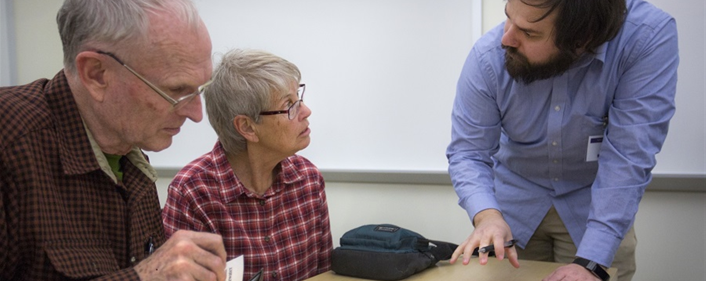 Whitewater community members Jerome and Barbara Converse receive information on their tax return from a volunteer preparer.