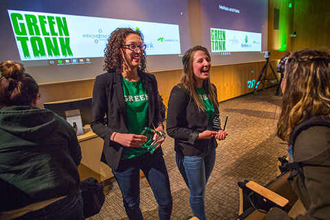 UW-Whitewater business students Melissa Khalil, left, and Kaitlin Amerling are congratulated on their first-place win in the Green Tank business plan competition for Earth Week.