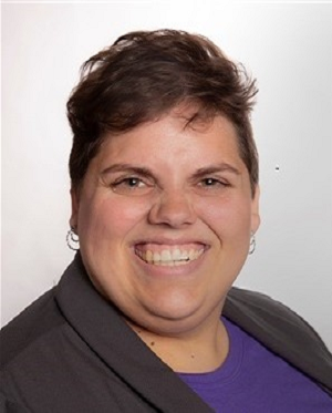 white woman in thirties with brown eyes and brown hair smiling