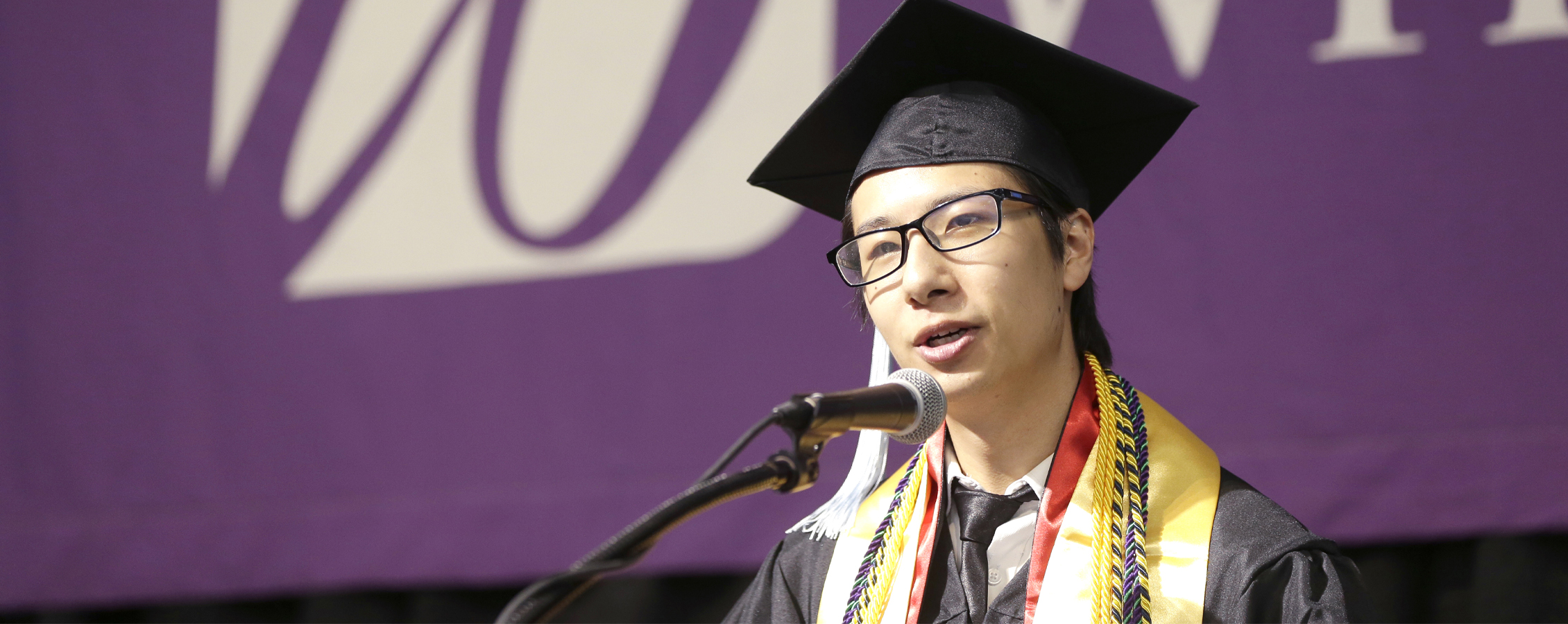 An international student from China gives a speech at graduation.