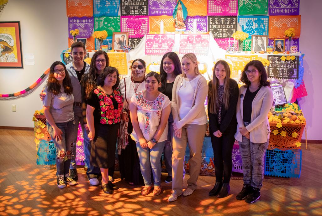 Members of the Spanish Club and Roberta's Art Gallery staff, including Veena Johnson, third from right, worked together to create the exhibit.