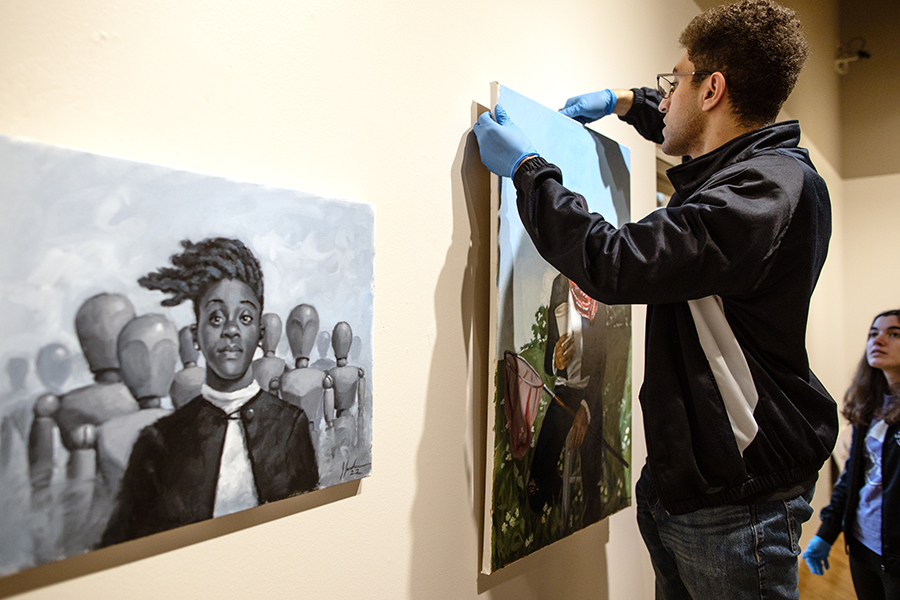 MAGD student Brian Michael works behind the scenes at Roberta's Art Gallery in the university Center.