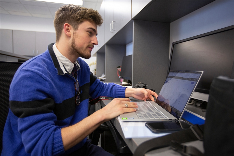 Professional on a laptop engaging in a webinar