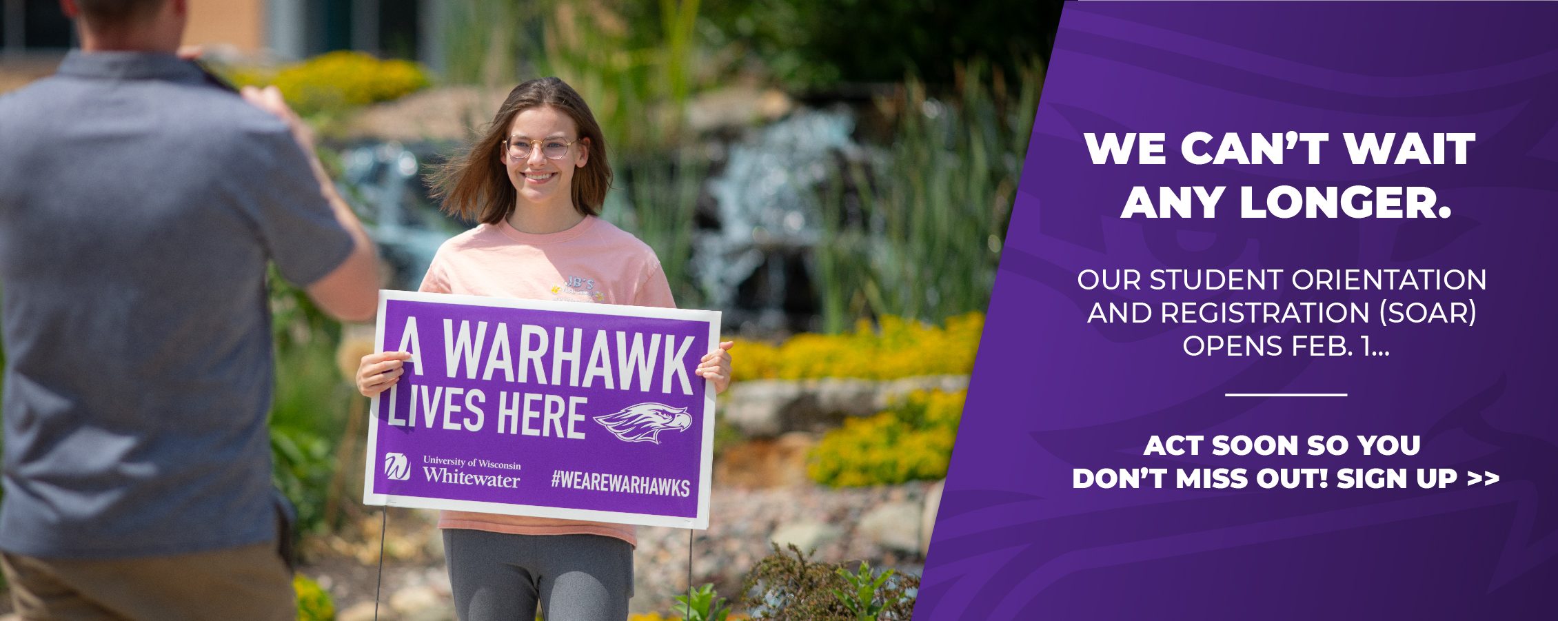 A student holds a sign that says a Warhawk lives here and copy that says Student Orientation And Registration opens February 1.