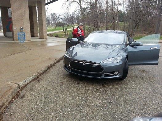 Man looking at a Tesla vehicle