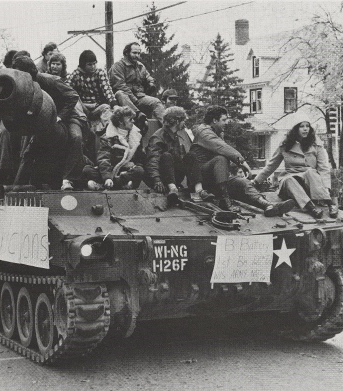 Students riding on top of a tank in the Homecoming Parade