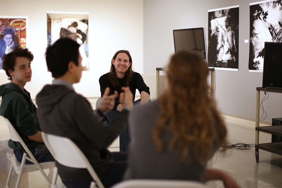 Jeff Herriott sits with students in the Crossman Gallery in the Greenhill Center of the Arts on the UW-Whitewater campus.