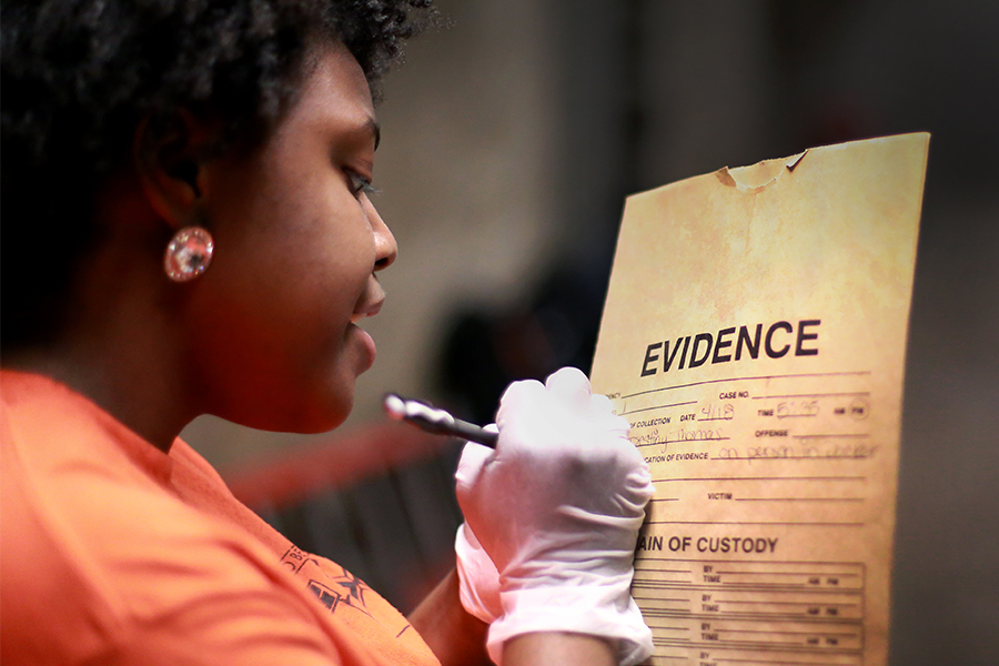 A student labels an evidence packet during a mock crime scene exercise created for forensic science students in the basement of Hyer Hall on the UW-Whitewater campus