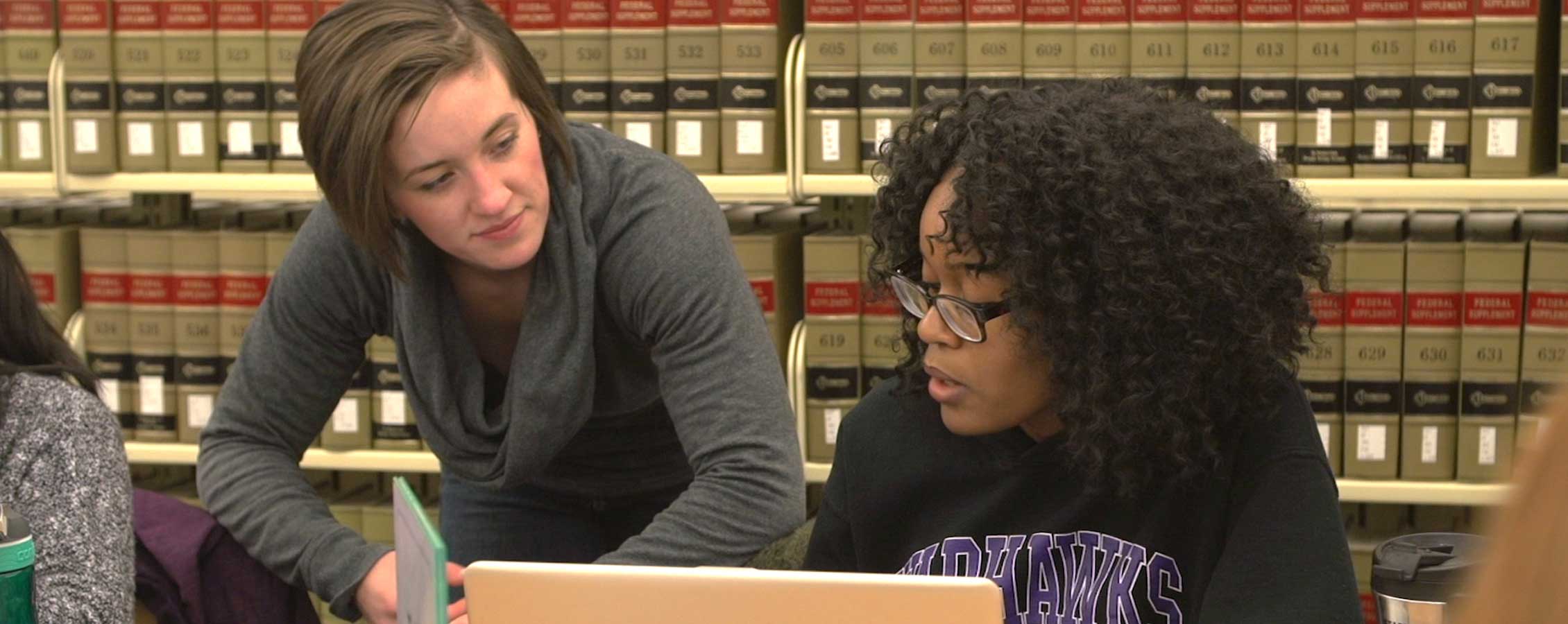 Two students study in the library.