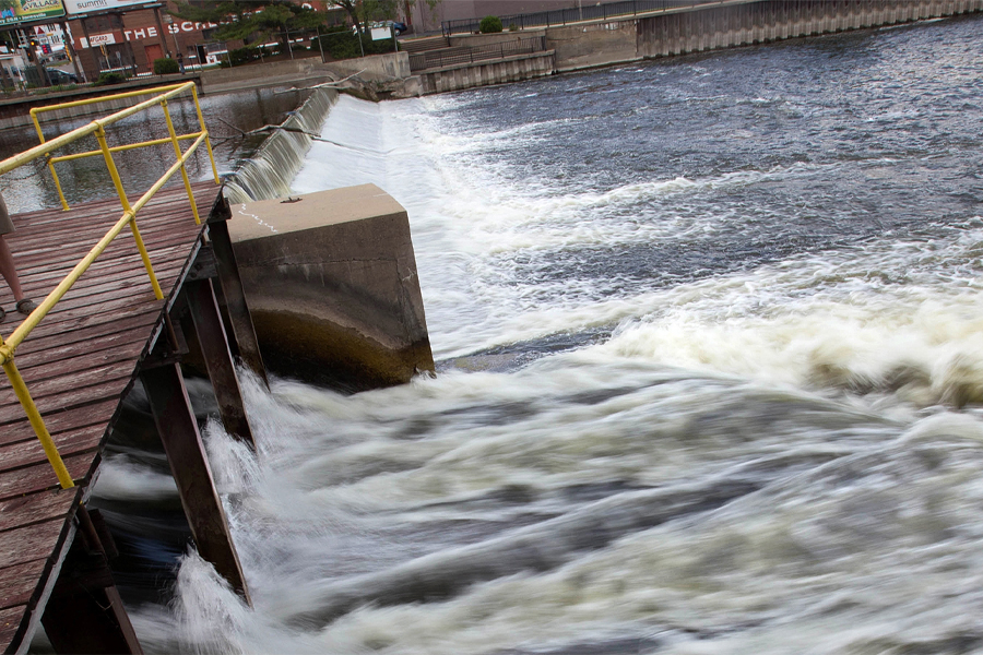 Water rushes over a dam.