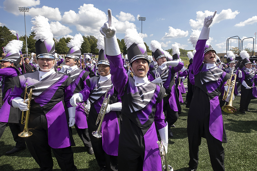 The Marching Band walks into Perkins Stadium wearing their new uniforms.