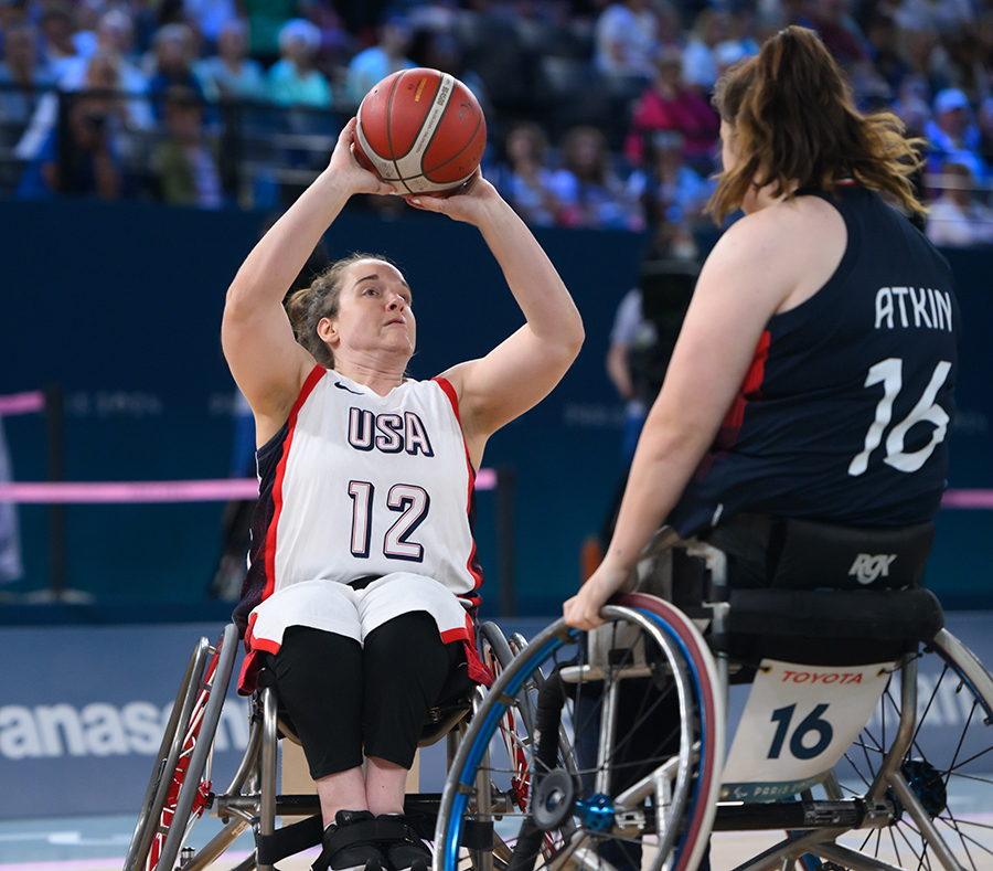 Becca Murray holds the basketball above her head in preparation to shoot the ball. 