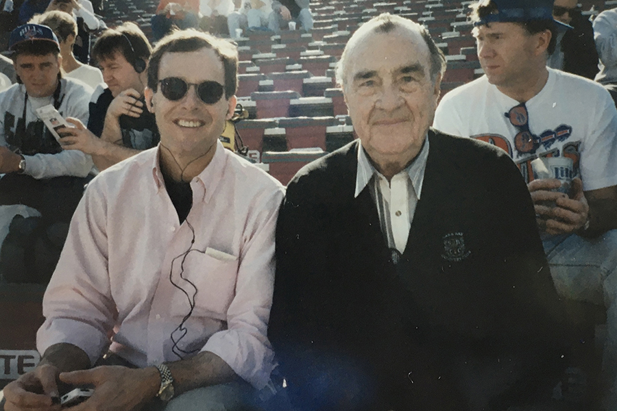 Mark and Harold Perry sit in the stands.