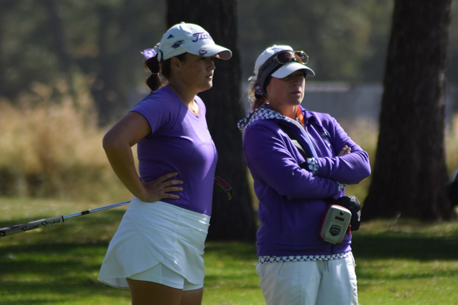 two athletes talking on the field