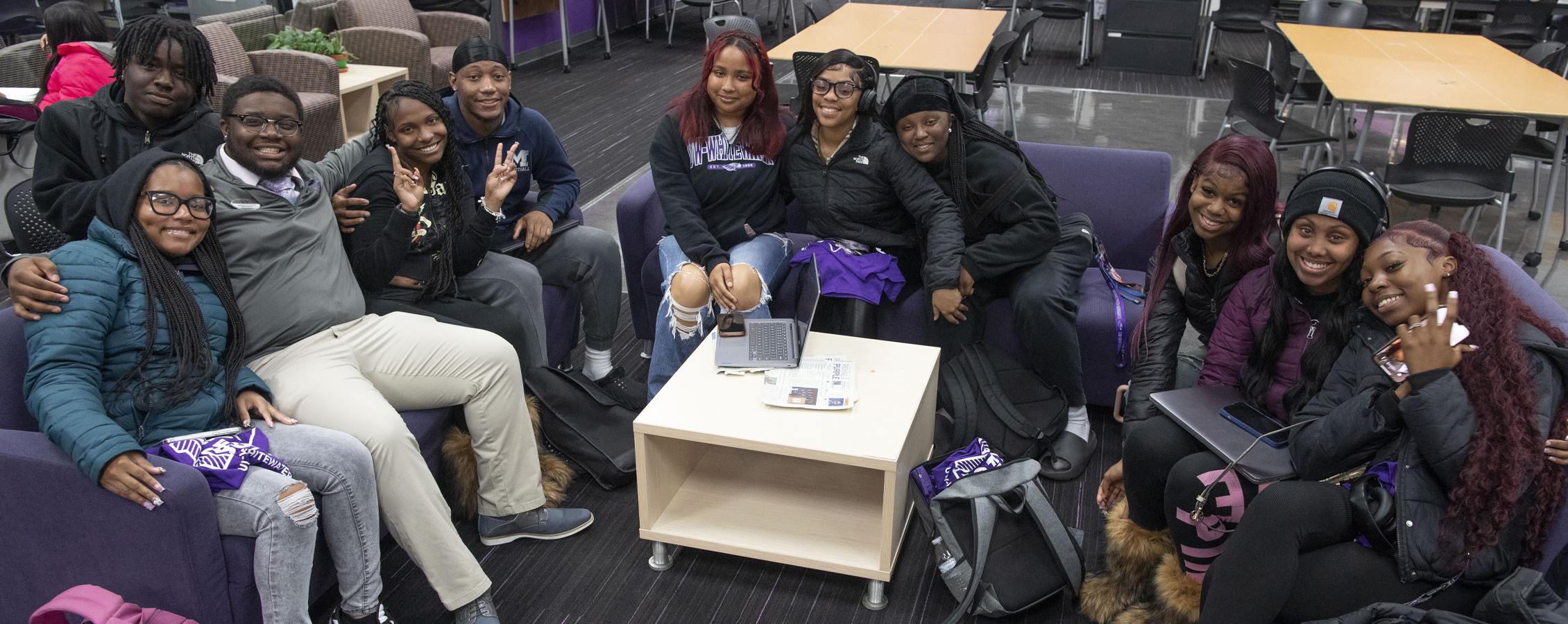 A group of students pose together in the Warhawk Connection Center.