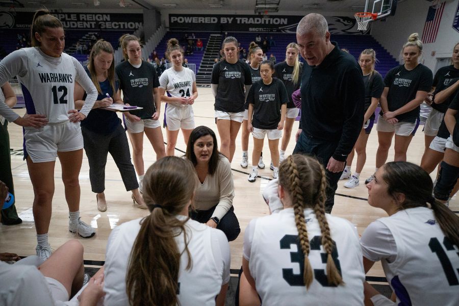 Head women's basketball coach Keri Carollo, center, and her husband Joe, an assistant, talk to players. 