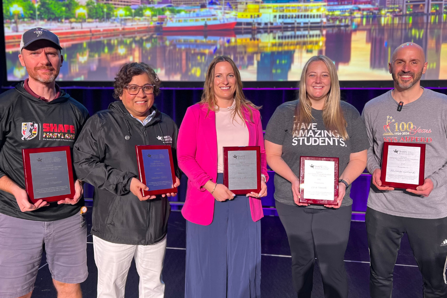 Photo of several teachers holding awards